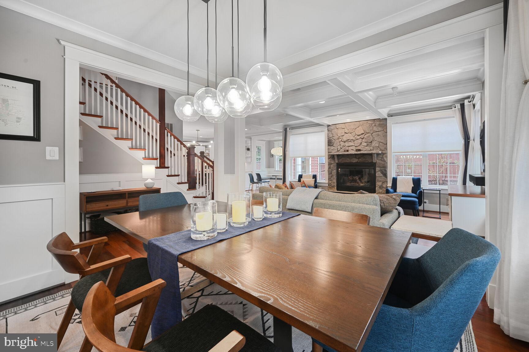 2107 Ellis Street Silver Spring, MD 20910 - Photo 14 of 63 a dining room with wooden floor a chandelier a wooden table and chairs