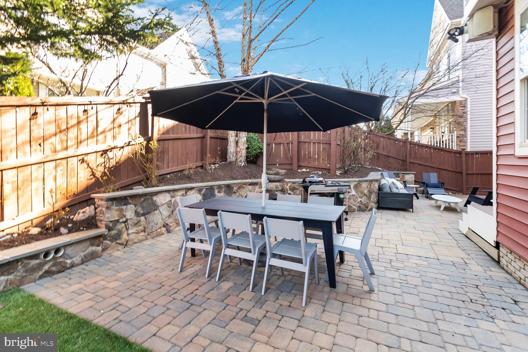 2107 Ellis Street Silver Spring, MD 20910 - Photo 22 of 63 a patio with a table and chairs under an umbrella