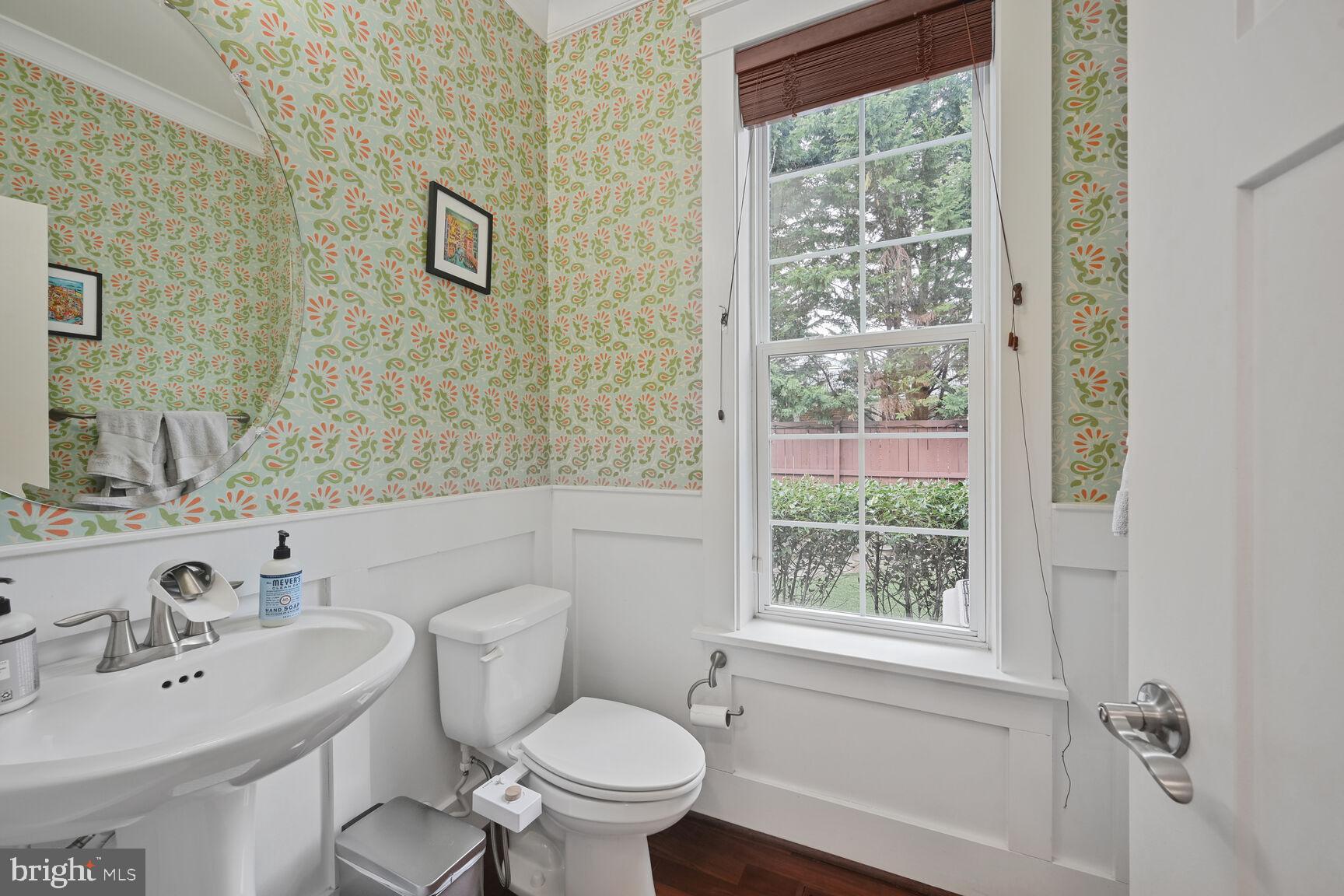 2107 Ellis Street Silver Spring, MD 20910 - Photo 29 of 63 a bathroom with a toilet a sink a mirror and a window