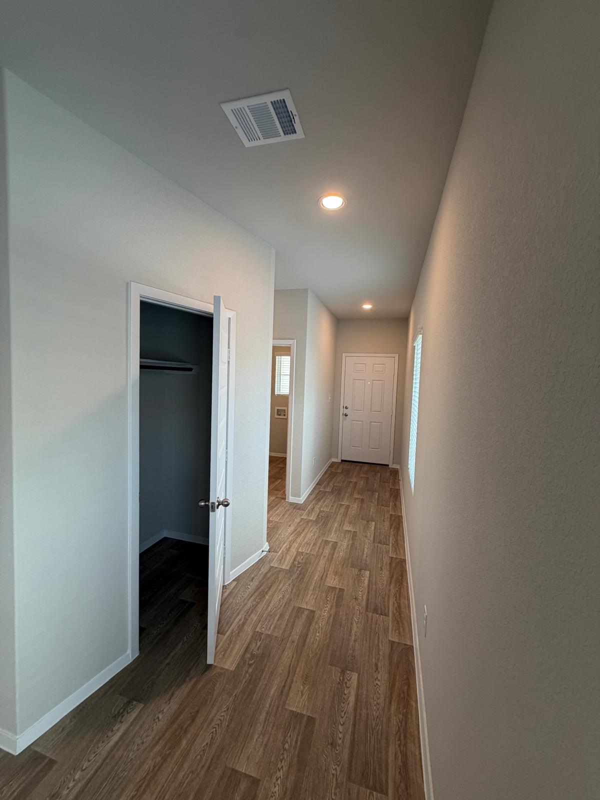 2701 Towy Road Manor, TX 78653 - Photo 6 of 35 A welcoming entry hallway features durable wood-look flooring and recessed ceiling lights.