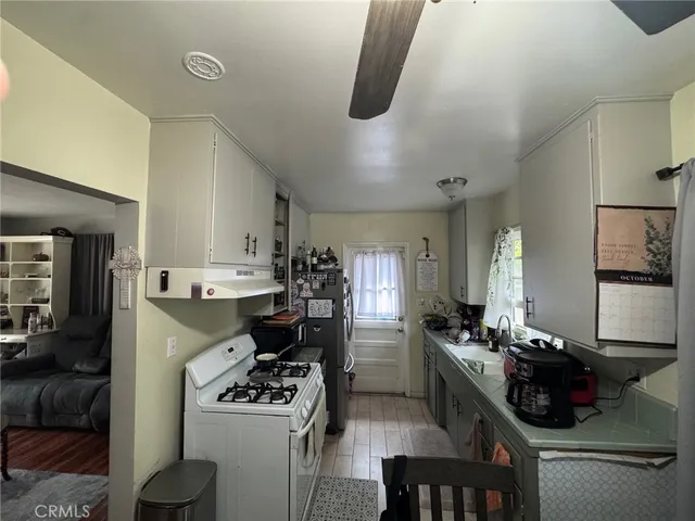 a kitchen with a sink appliances and cabinets