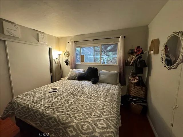 a bed sitting in a bedroom next to a window
