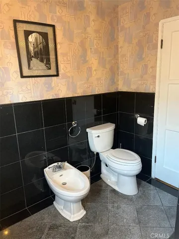 a white toilet sitting next to a bathroom sink