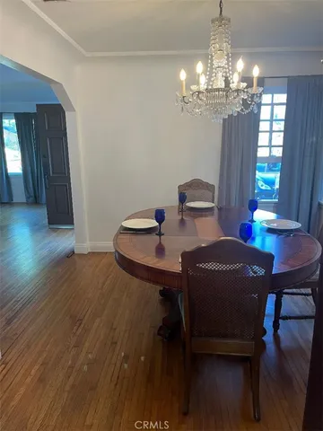 a view of a dining room with furniture and chandelier