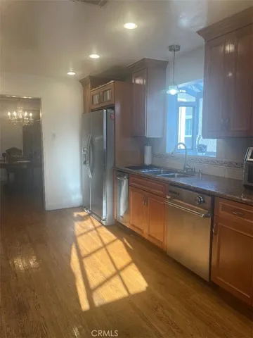 a kitchen with stainless steel appliances granite countertop a sink and a stove top oven