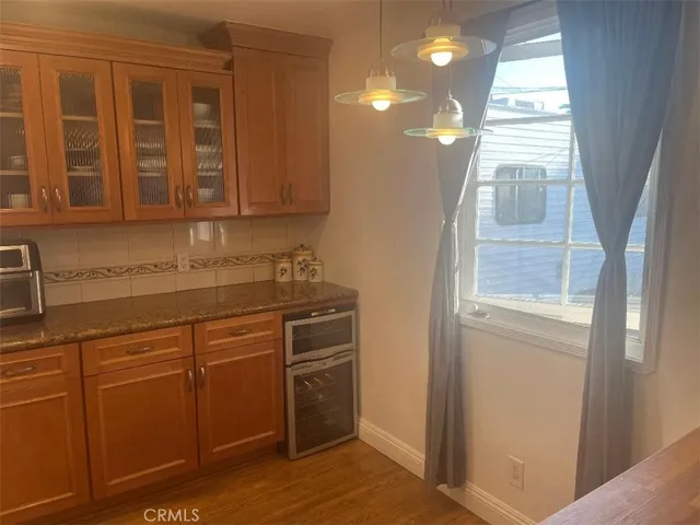 a kitchen with a sink cabinets and a window