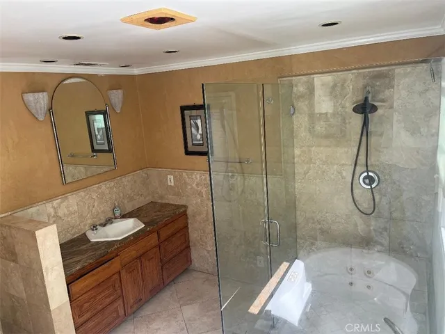a bathroom with a double vanity sink toilet and shower