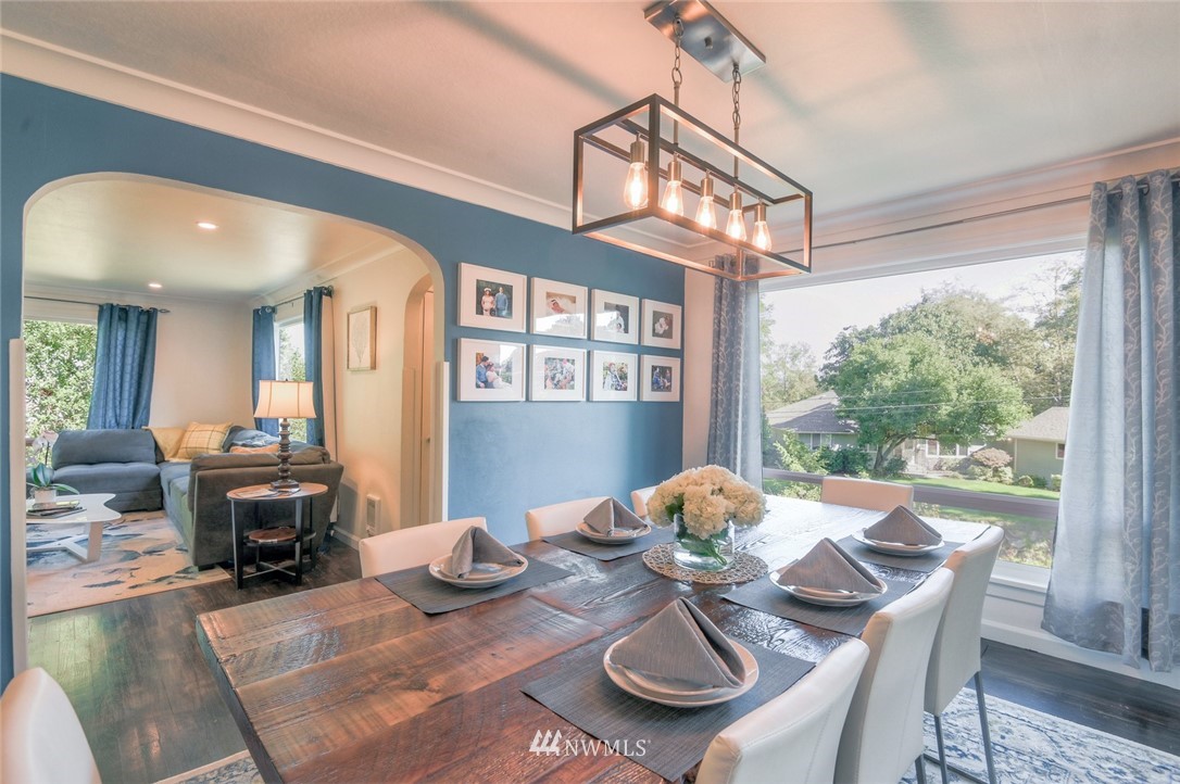 5802 Cady Road Everett, WA 98203 - Photo 11 of 25 a view of a dining room with furniture a chandelier and wooden floor