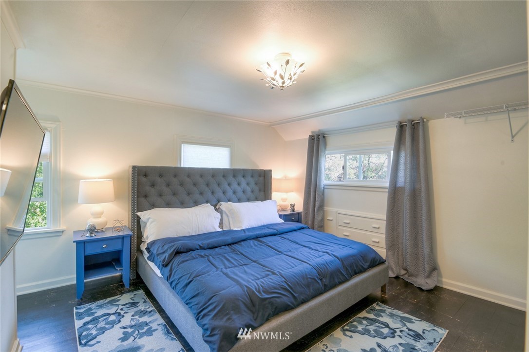 5802 Cady Road Everett, WA 98203 - Photo 12 of 25 a bedroom with a large bed and a chandelier