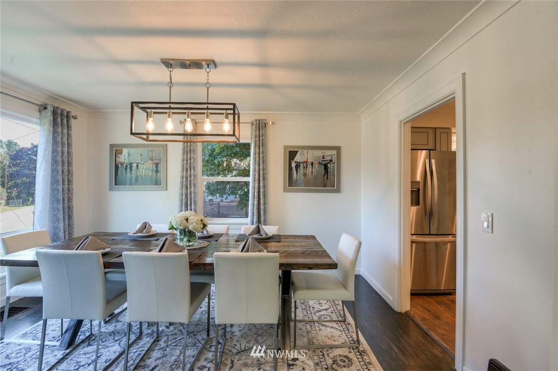 5802 Cady Road Everett, WA 98203 - Photo 9 of 25 a dining room with furniture a chandelier and wooden floor