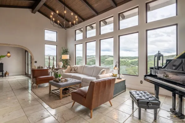 a living room with furniture and a floor to ceiling window