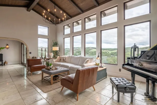 a living room with furniture and a floor to ceiling window