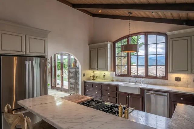 a open kitchen with stainless steel appliances granite countertop a stove a sink dishwasher and a refrigerator with wooden floor