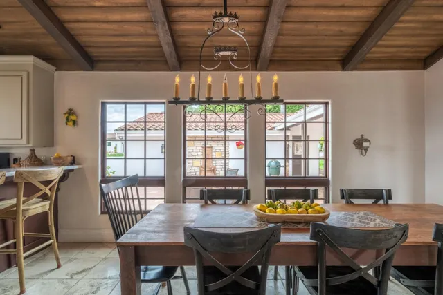 a dining room with furniture a chandelier and wooden floor