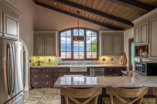 a kitchen with a stove a sink and a refrigerator