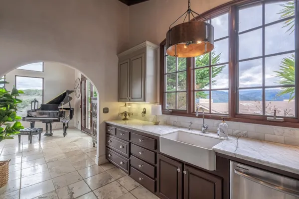 a kitchen with a sink and a large window