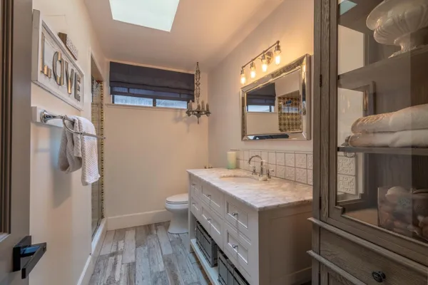 a bathroom with a double vanity sink and a mirror