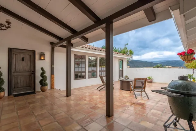 a view of a patio with table and chairs and potted plants