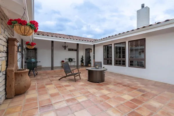 a front view of a house with sitting area