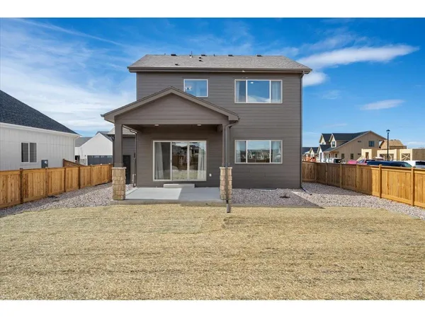 a view of a house with backyard porch and sitting area