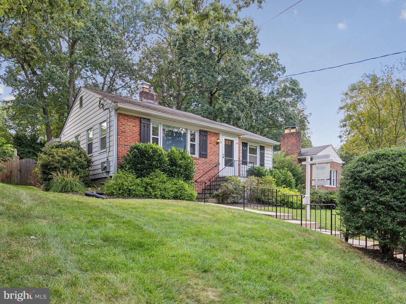 207 Whitmoor Terrace Silver Spring, MD 20901 - Photo 1 of 29 a front view of a house with a yard and trees