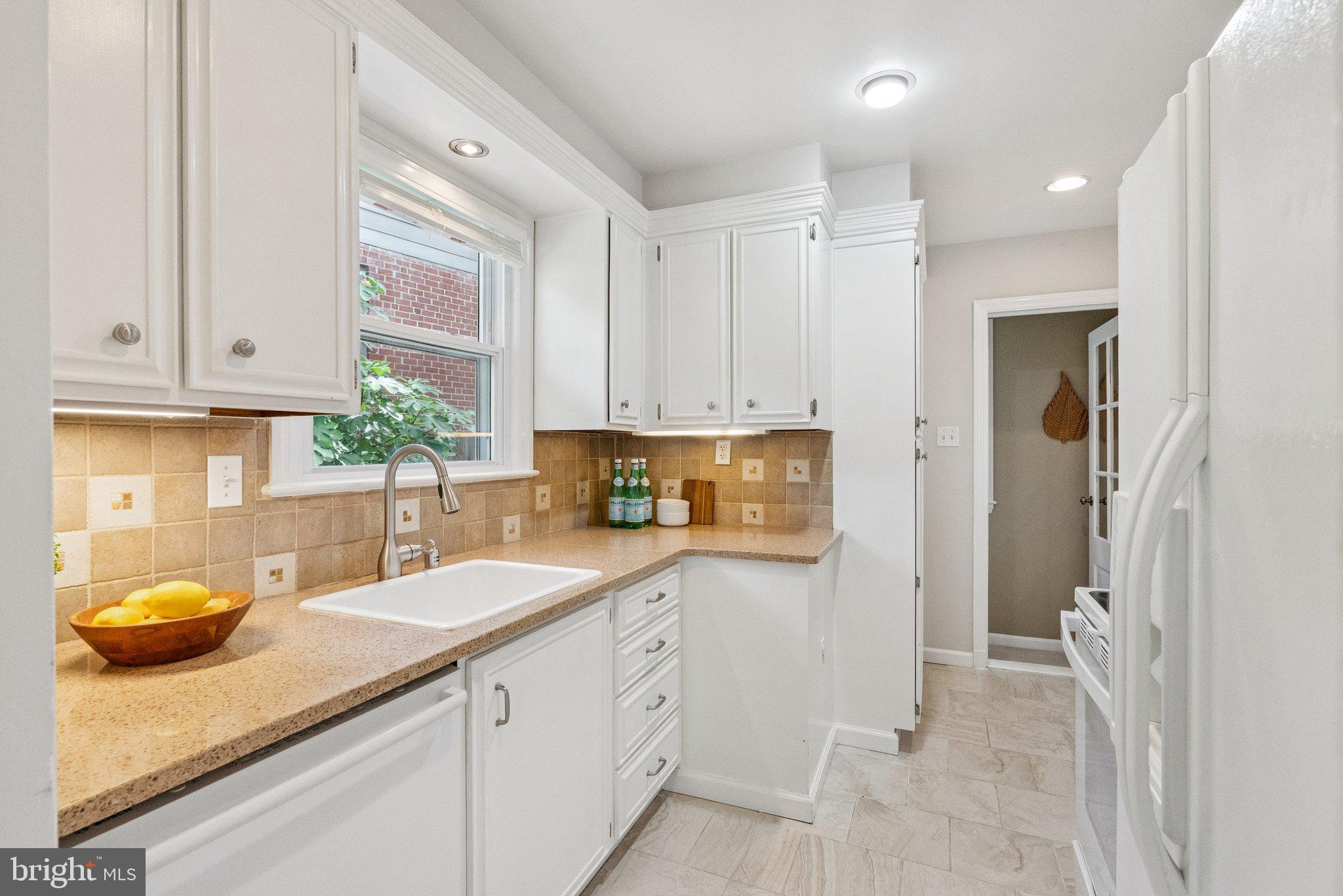 207 Whitmoor Terrace Silver Spring, MD 20901 - Photo 6 of 29 a kitchen with a sink and cabinets