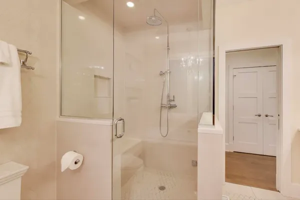 a bedroom with a bed a mirror and lamp on desk