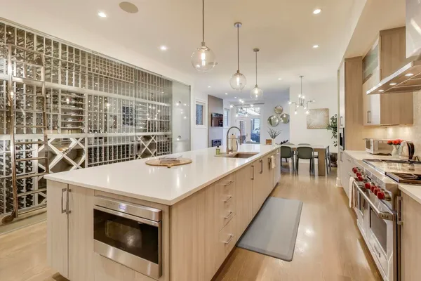 a kitchen with stainless steel appliances a sink stove and cabinets
