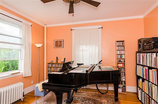 5 Colliston Road, Unit 1 Boston, MA 02135 - Photo 3 of 11 a living room with furniture a bookshelf and a window