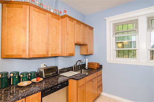 5 Colliston Road, Unit 1 Boston, MA 02135 - Photo 5 of 11 a kitchen with stainless steel appliances granite countertop a sink stove and cabinets