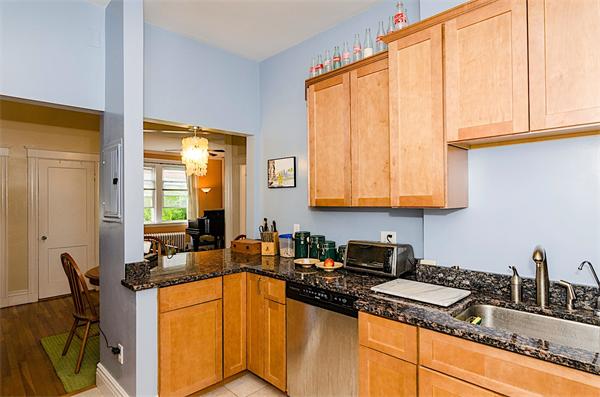 5 Colliston Road, Unit 1 Boston, MA 02135 - Photo 6 of 11 a kitchen with stainless steel appliances granite countertop a stove a sink and a microwave