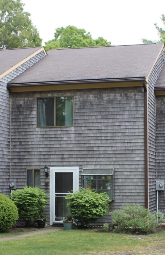 25 Round House Road Bourne, MA 02532 - Photo 3 of 32 a front view of a house with a yard and potted plants