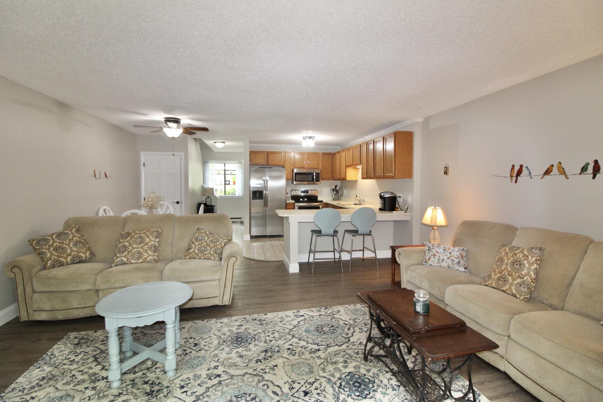 25 Round House Road Bourne, MA 02532 - Photo 10 of 32 a living room with furniture and a dining table with kitchen view