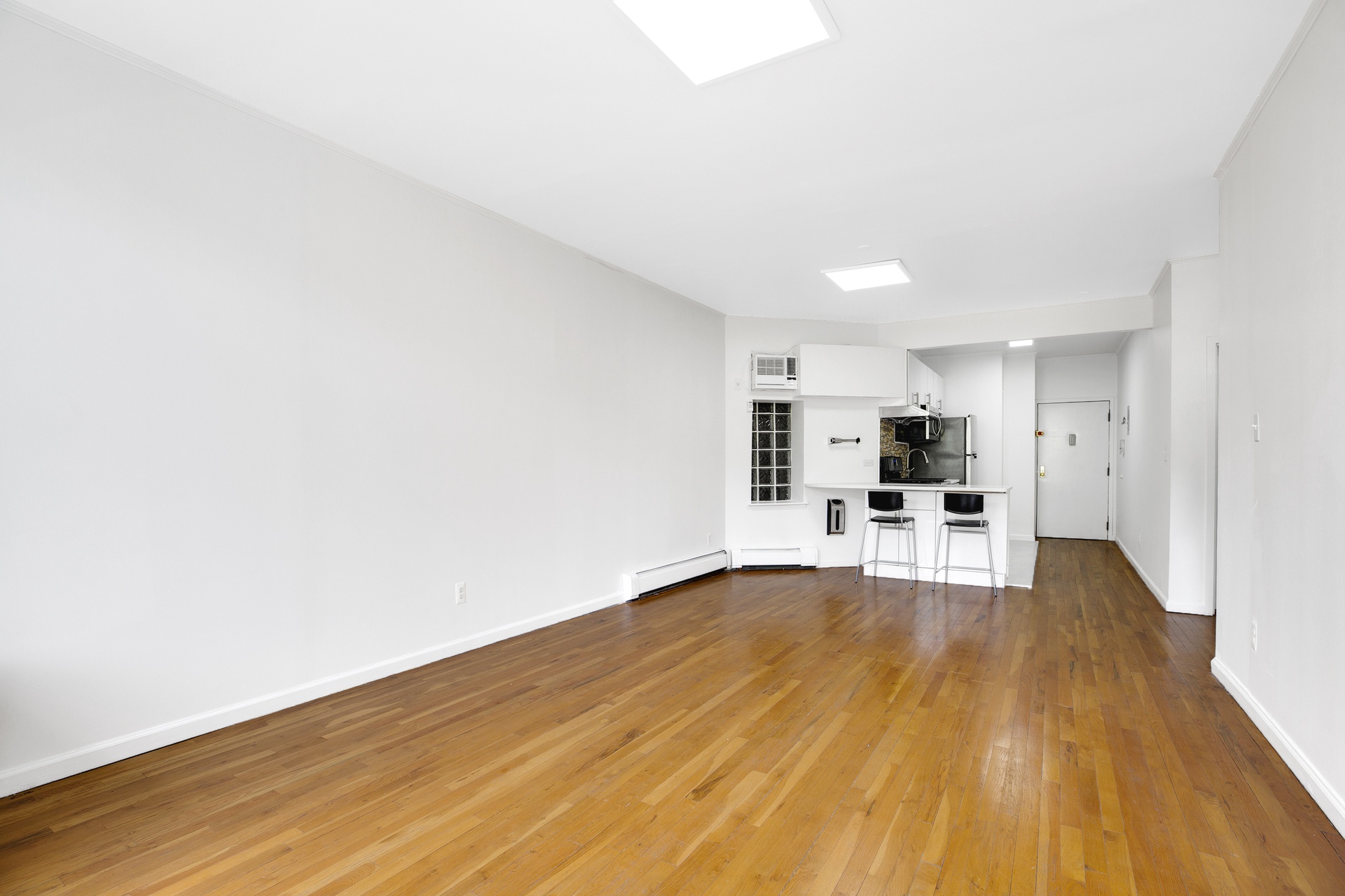 2322 Adam Clayton Powell Jr Boulevard, Unit 3F Manhattan, NY 10030 - Photo 2 of 14 a view of kitchen with wooden floor and chairs