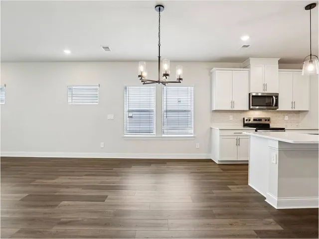 a kitchen with stainless steel appliances a refrigerator sink and microwave