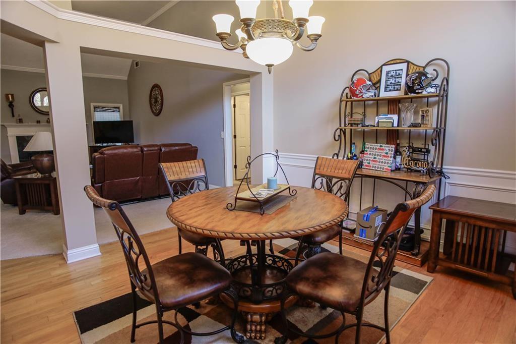 3875 Spring Manor Court Loganville, GA 30052 - Photo 13 of 23 a view of a dining room with furniture and wooden floor