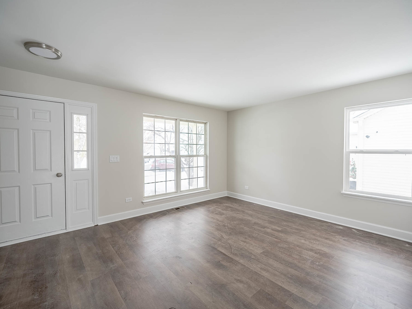 2084 Kentland Drive Romeoville, IL 60446 - Photo 2 of 15 an empty room with wooden floor and windows