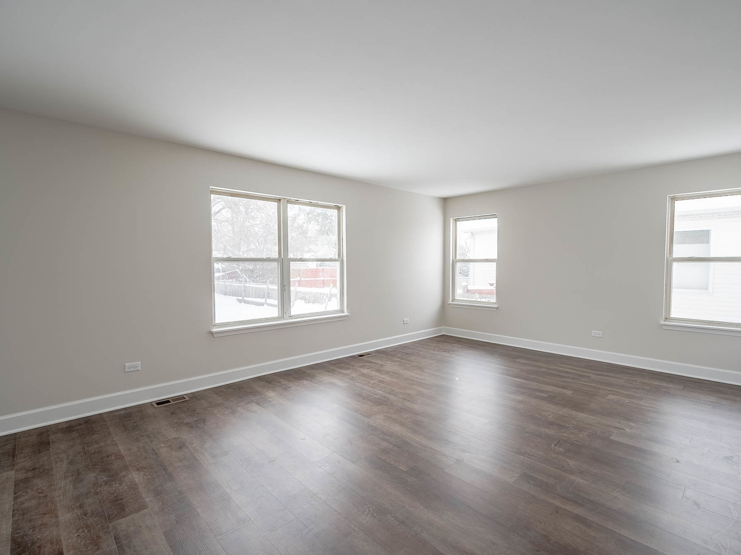 2084 Kentland Drive Romeoville, IL 60446 - Photo 4 of 15 an empty room with wooden floor and windows