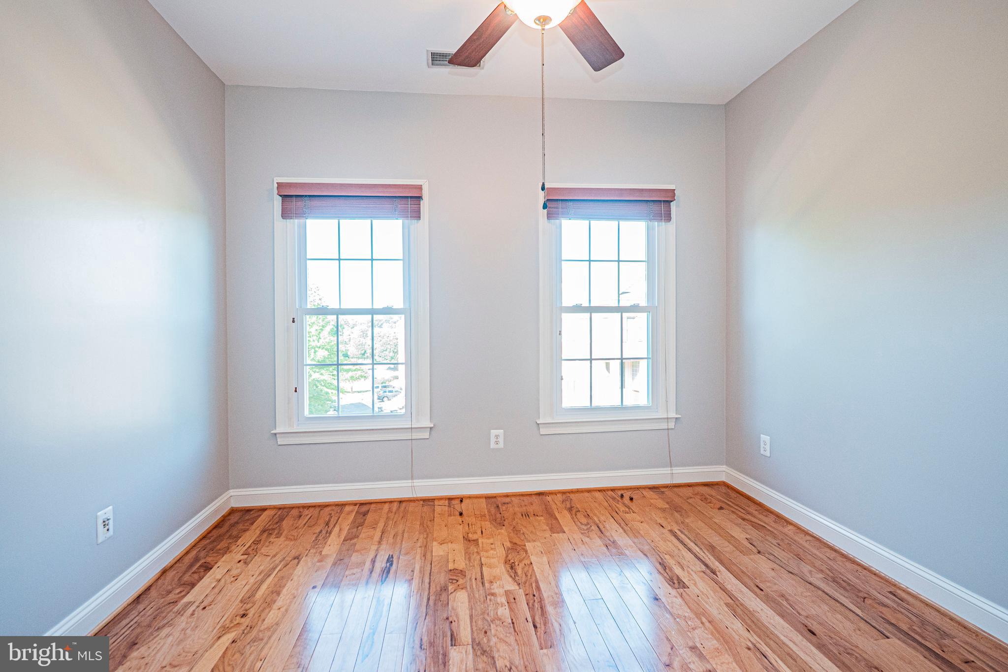 5448 Edsall Ridge Place Alexandria, VA 22312 - Photo 30 of 52 an empty room with wooden floor and windows