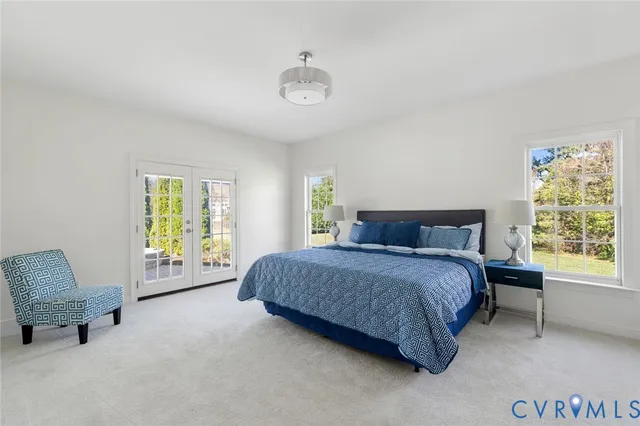 a spacious bedroom with a bed and a window