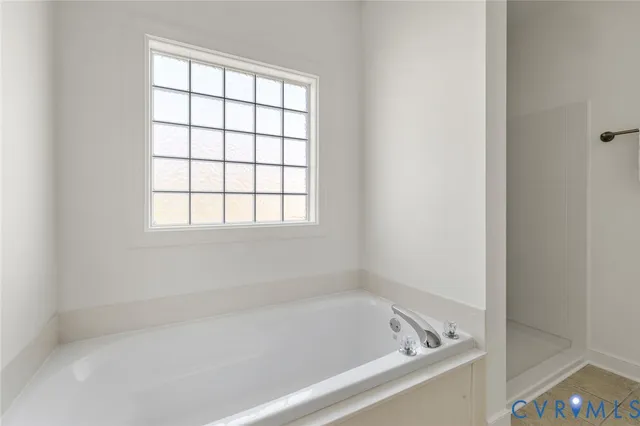 a white bath tub sitting next to a window