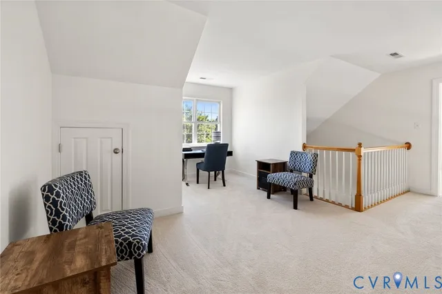 a living room with furniture and a chair