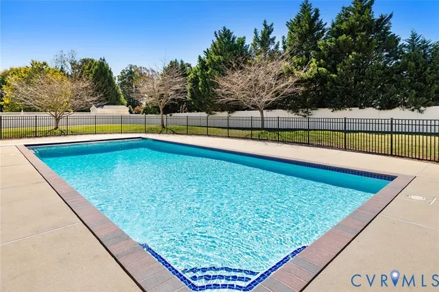 a view of swimming pool with a lounge chair