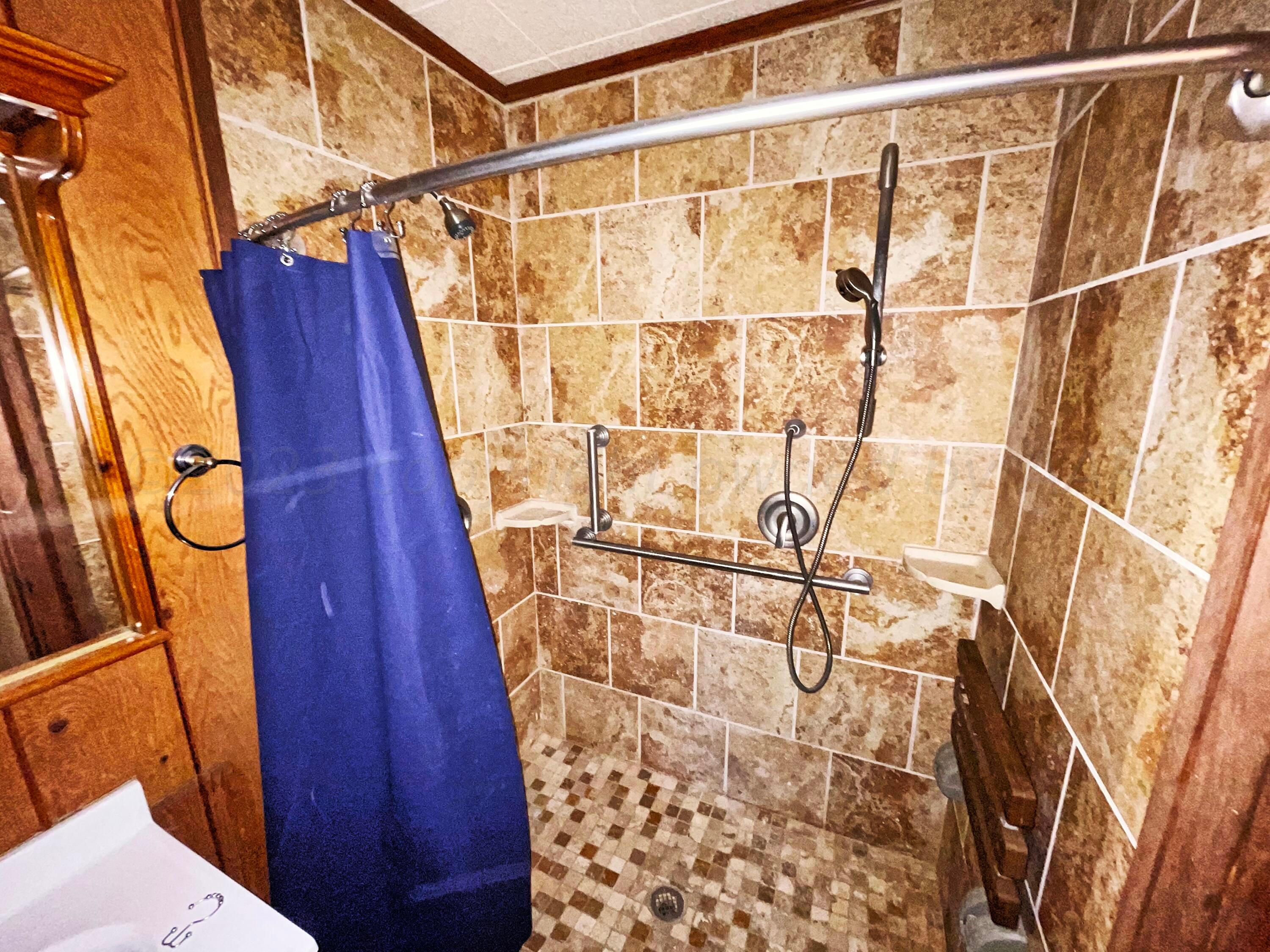 415 Southwest 5th Avenue Perryton, TX 79070 - Photo 11 of 16 a bathroom with a shower curtain and a shower curtain