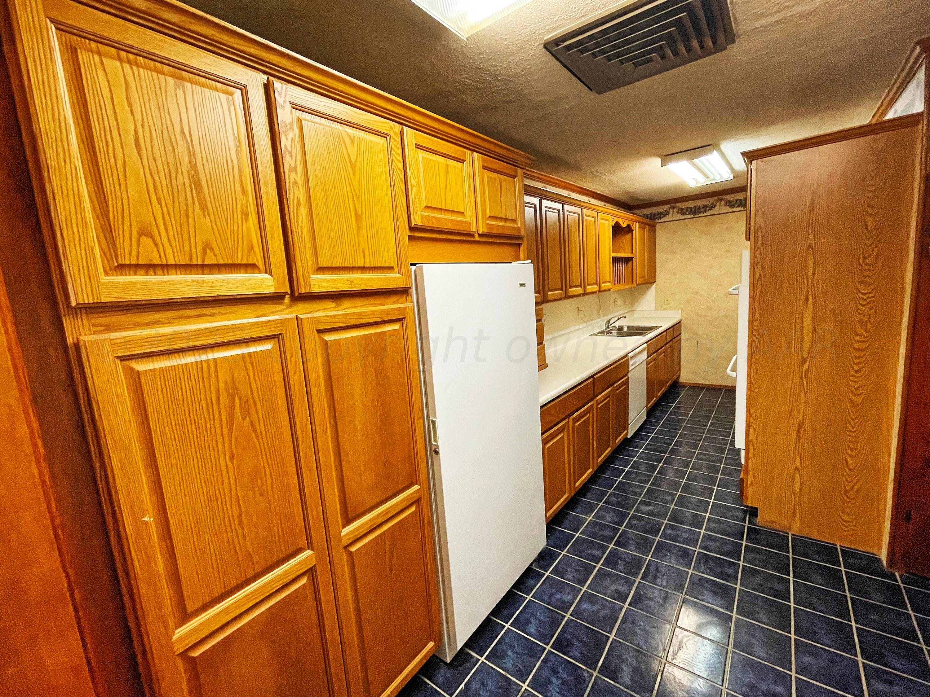 415 Southwest 5th Avenue Perryton, TX 79070 - Photo 4 of 16 a bathroom with a sink a mirror and shower