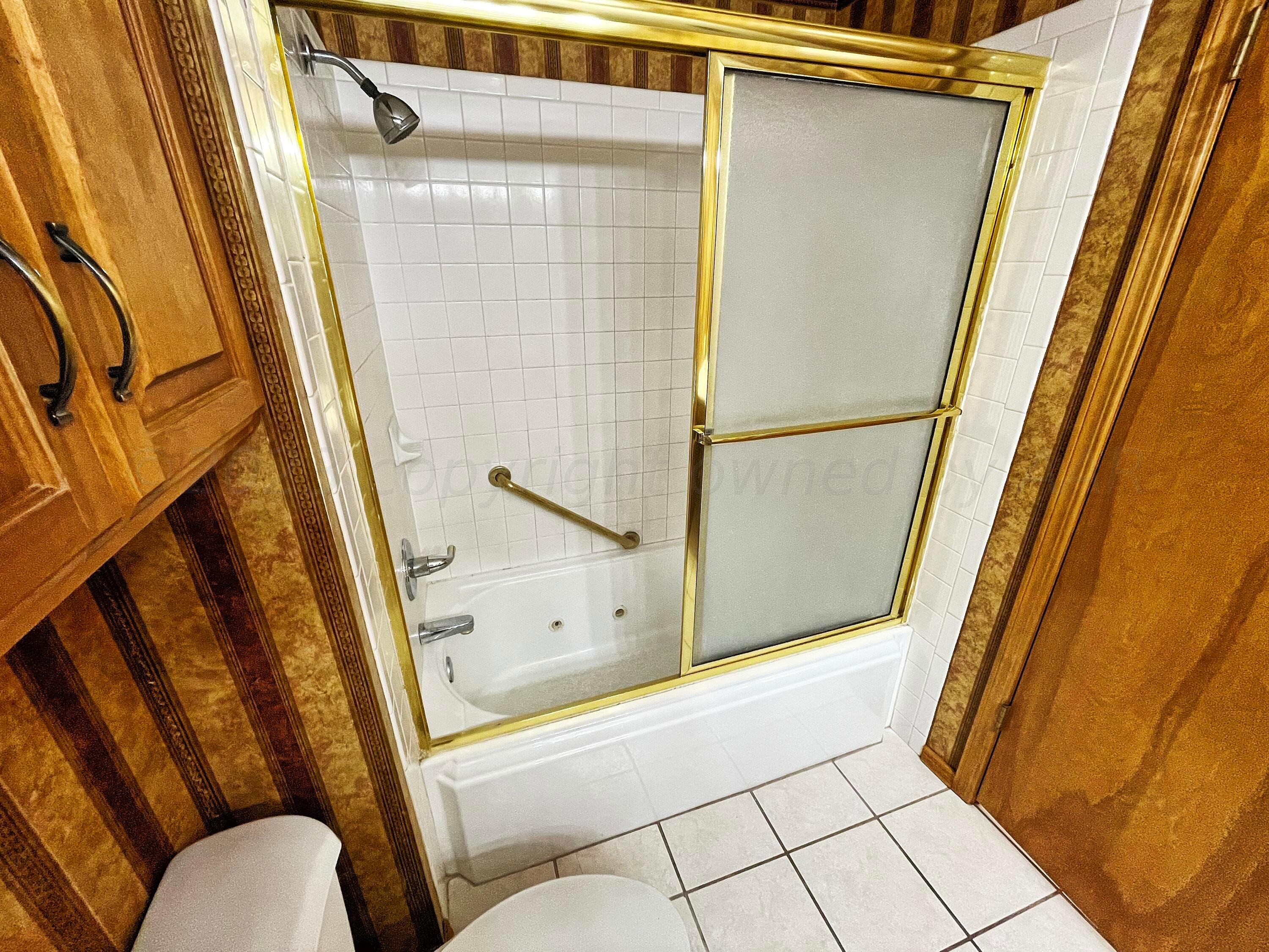 415 Southwest 5th Avenue Perryton, TX 79070 - Photo 8 of 16 a bathroom with a tub and a shower