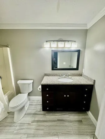 a bathroom with a toilet a sink and a mirror