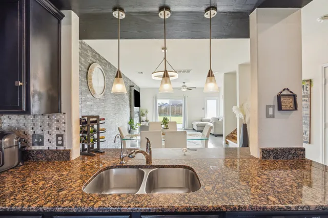 a living room with fireplace furniture and a chandelier