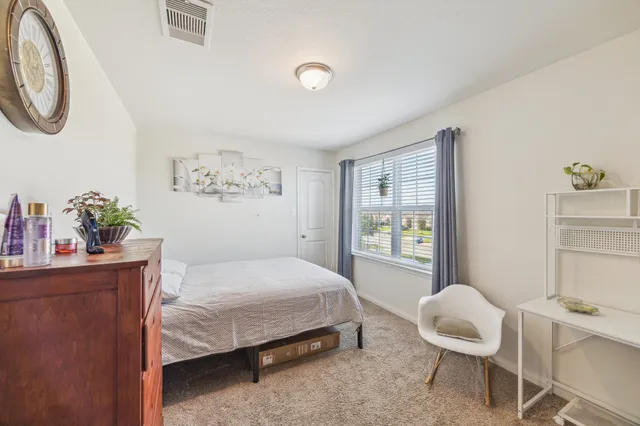 a bedroom with a bed and a window