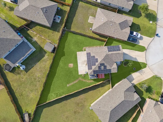 an aerial view of a house with a garden and swimming pool